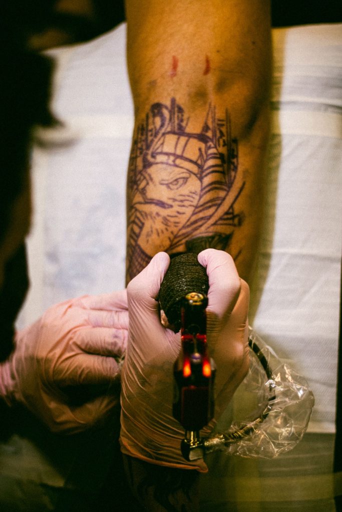 Close-up of detailed tattoo being inked on a forearm