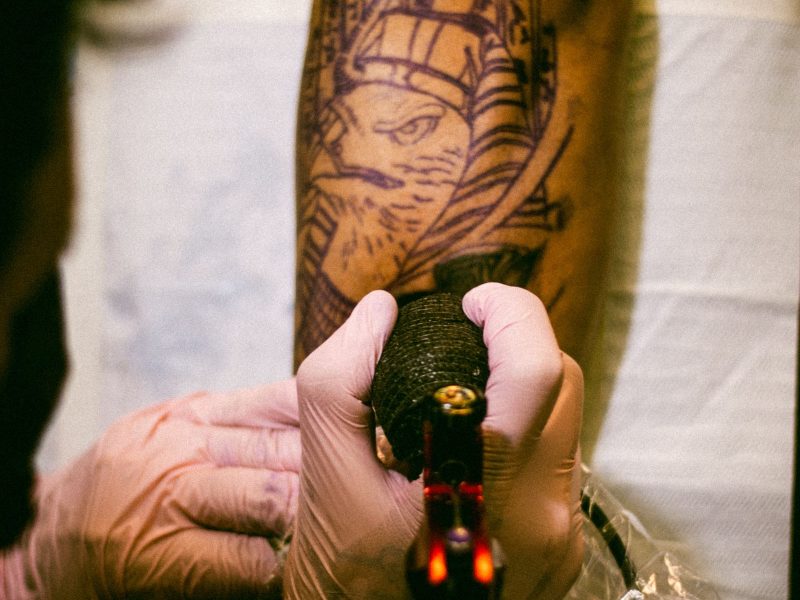 Close-up of detailed tattoo being inked on a forearm