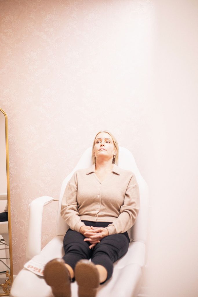 Woman relaxing in a modern medical spa lounge