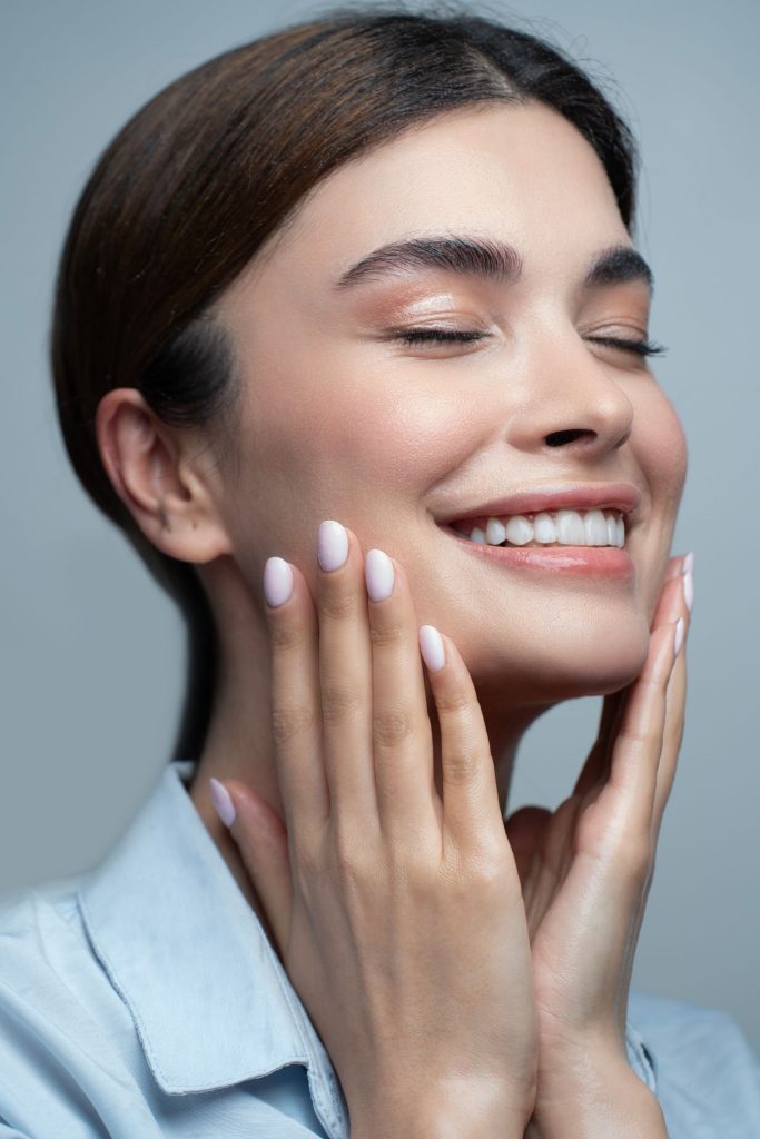 Smiling woman with radiant, glowing skin