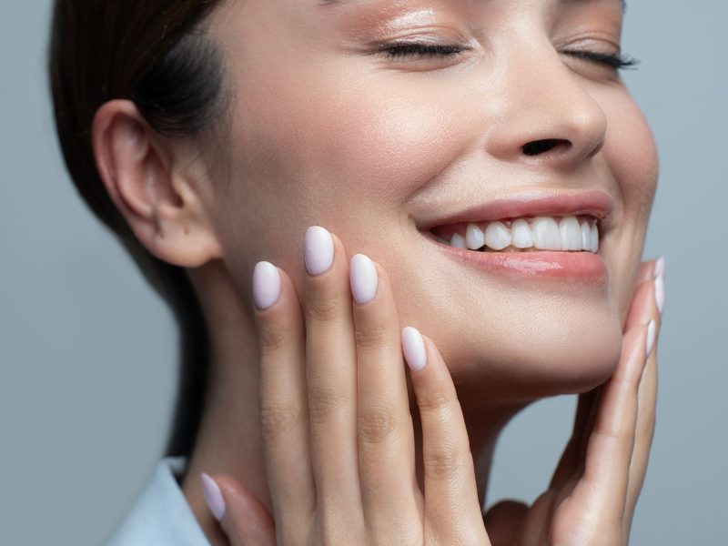 Smiling woman with radiant, glowing skin