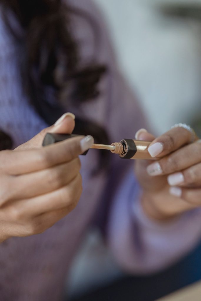Close-up of a woman applying makeup to her face