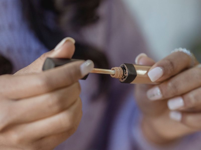 Close-up of a woman applying makeup to her face