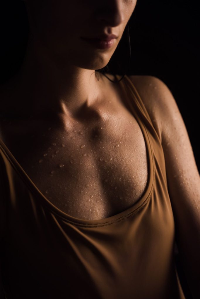 Close-up of a woman with water droplets on her skin