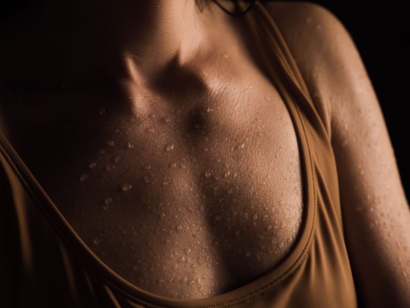 Close-up of a woman with water droplets on her skin